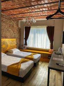 a bedroom with two beds and a large window at AYSA Hotel in Istanbul