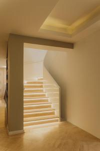 a staircase in an empty room with white stairs at Kokoa Hotel Cusco in Cusco