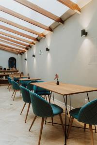 a row of tables and chairs in a room at Kokoa Hotel Cusco in Cusco