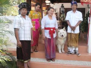 a group of people standing on a porch with a dog at Bali North Beach Villa - Ocean Front in Tianyar