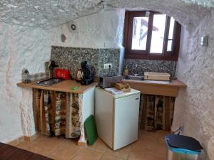 a small kitchen with a counter and a sink at Cuevas Barrio Las Santas in Huéscar