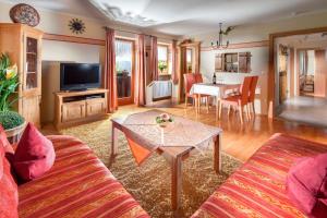 a living room with a couch and a table at Gästehaus Lärcheck Berchtesgaden FeWo Morgensonne in Berchtesgaden