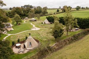 an aerial view of a village with tents in a field at Scaldersitch Farm Boutique Camping Tipi with private wood fired hot tub in Sheen