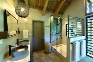a bathroom with a sink and a shower at ChamGaia off-grid eco-villa in Chamarel