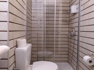 a bathroom with a toilet and a glass shower at Sea Front Old Town in Rethymno Town