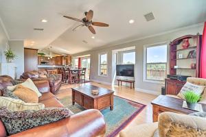 a living room with leather furniture and a ceiling fan at Scenic Mancos Hideaway Less Than 2 Mi to Mesa Verde! in Mancos