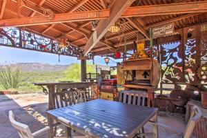 a wooden table and chairs on a patio with a grill at Unique Phoenix Abode with 2-Tier Patio and Grills in Anthem