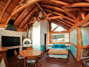 a bedroom with a bed and a table in a room at Blue Bird House in San Carlos de Bariloche