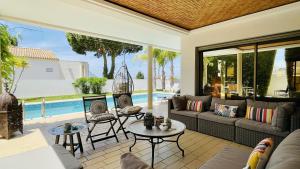 a living room with a couch and chairs and a pool at Praia by Check-in Portugal in Albufeira +36 photos