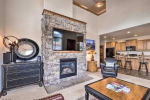 a living room with a stone fireplace with a tv at Midway Getaway 17 Miles to Park City Resort! in Midway