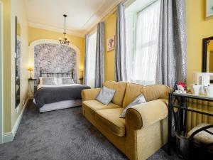 a living room with a couch and a bed at McCarthy's B&B in Clonmel