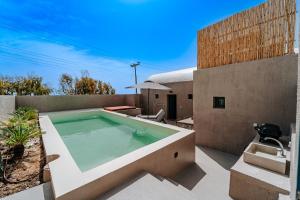 a swimming pool on the patio of a house at Present Perfect Villa - private pool in Firostefani