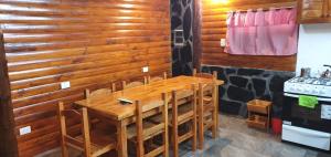 a wooden dining room with a table and chairs at Cabañas kymey in San Clemente del Tuyú