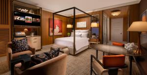 a hotel room with a bed and a living room at Wynn Las Vegas in Las Vegas