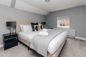 a bedroom with a large bed and a window at The Mulberry in Henley on Thames