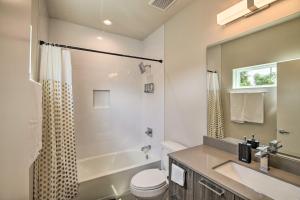 a bathroom with a sink and a toilet and a tub at Spacious Townhome Less Than 2 Mi to Downtown Houston! in Houston +21 photos