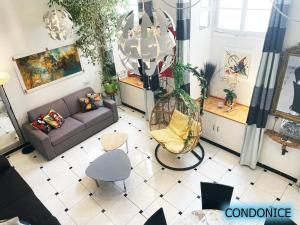 an overhead view of a living room with a couch and chairs at CondoNice in Nice