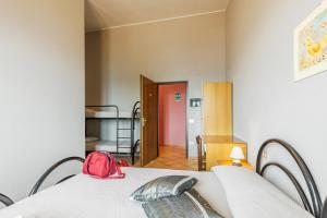 una habitación con una cama con una bolsa roja. en Ostello Bellavista, en Santa Maria Navarrese