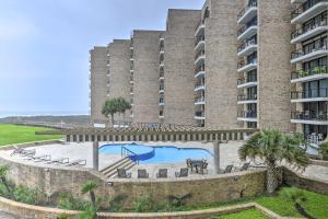 a large building with a swimming pool and a resort at Port Aransas Condo Community Perks, Walk to Beach in Port Aransas