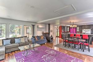 a living room with a couch and a table at Vibrant Weaverville Escape with Deck and Creek! in Weaverville