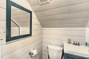 a bathroom with a toilet and a sink at Fragola House - Family-Friendly Getaway! in Clifton Heights +19 photos