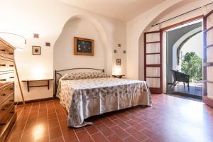 a bedroom with a bed and a large window at Il Posto delle Fragole in Castro di Lecce