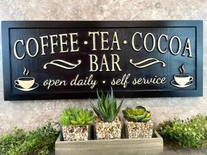 a sign for a coffee tea bar on a wall at The Orca Inn in Friday Harbor
