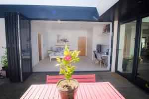 a patio with a table with a vase of flowers on it at Allen Ridge in Hythe