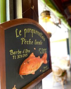 a sign with a picture of a fish on it at Hôtel Le Porquerollais in Porquerolles
