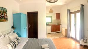 a bedroom with a large bed and a kitchen at Golden Sun in Parga