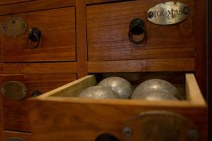 a wooden drawer with balls inside of it at Hôtel Le Porquerollais in Porquerolles