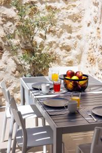 a table with a bowl of apples and a bowl of fruit at VaSan suite in Rethymno