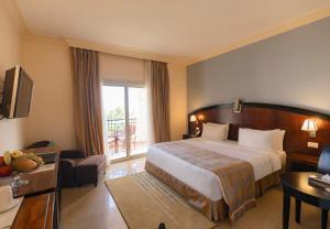 a hotel room with a bed and a balcony at Stella Di Mare Beach Hotel & Spa in Sharm El Sheikh