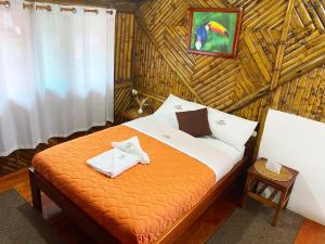 a bedroom with a bed in a straw room at La Posada de Mindo in Mindo