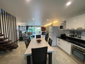 a kitchen with a table and chairs in a room at Villa Luxe AP06 in Kamala Beach