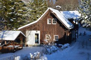 a cabin in the snow with snow covered trees at Stockerhütte - Ferienhaus in Vorderstoder