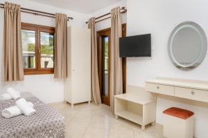 a hotel room with a bed and a mirror at PENSION STELIOS in Ouranoupoli