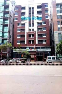 a large building with a sign on the side of it at Marry House in Dhaka