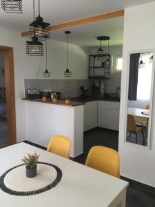 a kitchen and dining room with a table and chairs at KATÓ APARTMAN in Siófok