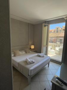 a bedroom with a bed and a large window at Terrazzo Del Borgo in Tropea