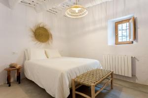 A bed or beds in a room at Casa Santiago House Boutique