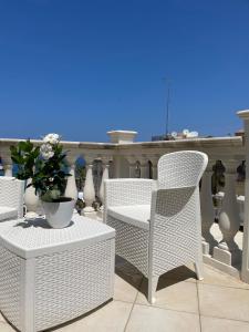 a group of chairs and a table with a potted plant at Terrazzo Del Borgo in Tropea