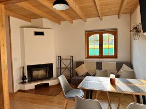 a living room with a table and a couch at Stolove Chatki Radków in Radków