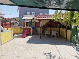 
a patio area with chairs, tables and umbrellas at Apartments Maja in Star Dojran
