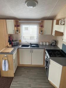 A kitchen or kitchenette at Calypso Hot Tub Breaks Tattershall Lakes Pet Friendly