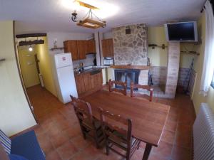 a kitchen and dining room with a table and a fireplace at Fuente Del Gamellon in Buenache de la Sierra
