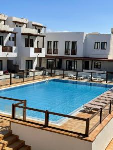 a large swimming pool on top of a building at Dúplex Calero Sunset in Yaiza