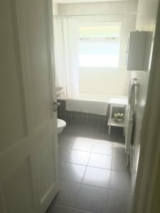 a bathroom with a window and a sink and a toilet at Hollybanks in Moycullen