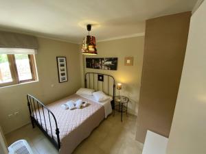 a bedroom with a bed and a chandelier at Two-storey Mansion at the Sea in rkadiko Chorio