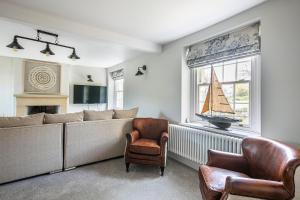 a living room with a couch and a sailboat on a window at The Belle - A lovingly converted Grade II Listed home from home in Bakewell in Bakewell